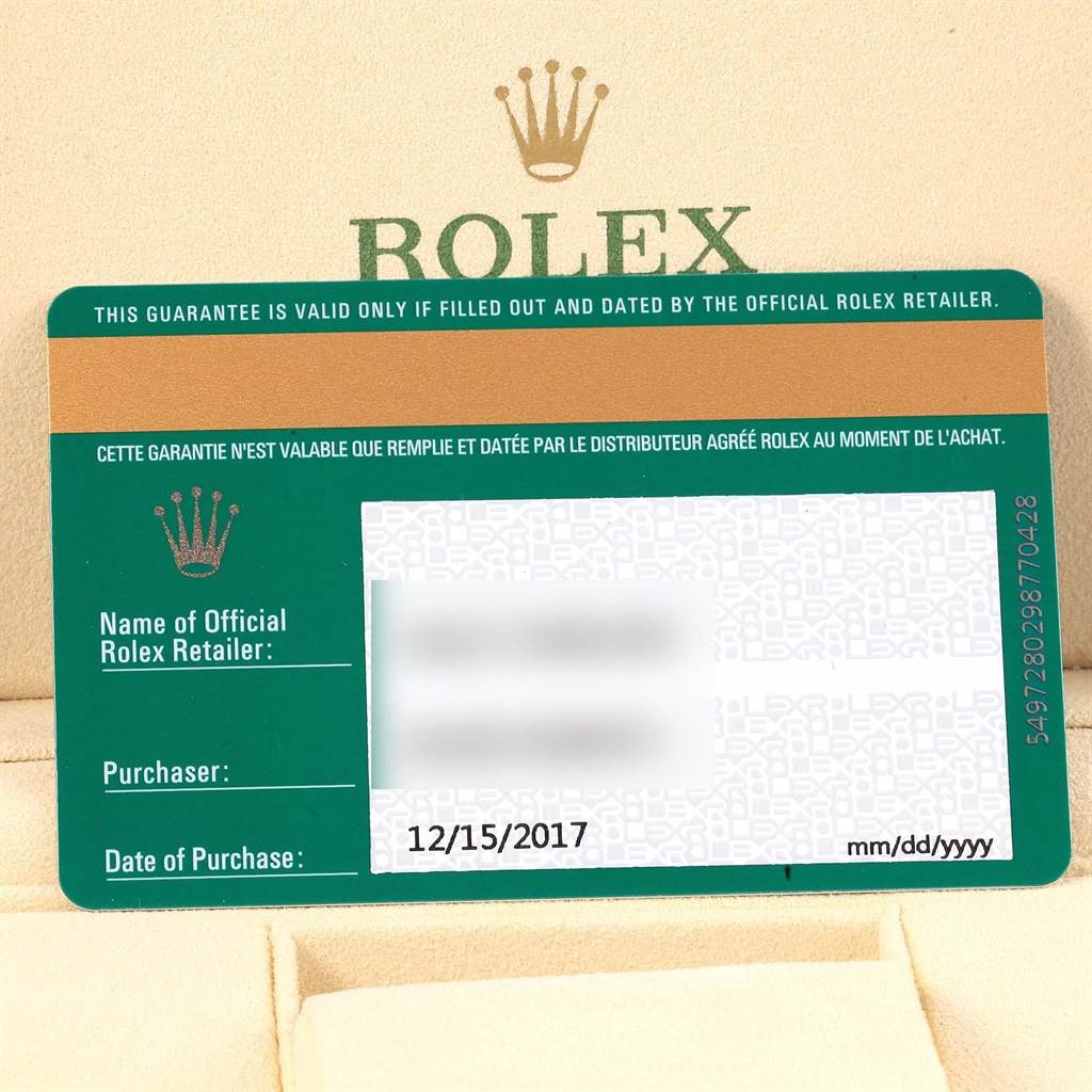 The image shows a close-up of the warranty card for a Rolex Oyster Perpetual 114200 Stainless Steel Green Dial 114200 Stainless Steel Green Dial watch.