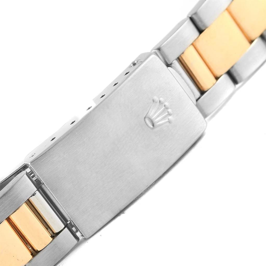 The image shows the clasp part of a Rolex Oyster Perpetual 14233 Men's Steel and Gold (two tone) White Dial 14233 Men's Steel and Gold (two tone) White Dial watch bracelet in a close-up angle.