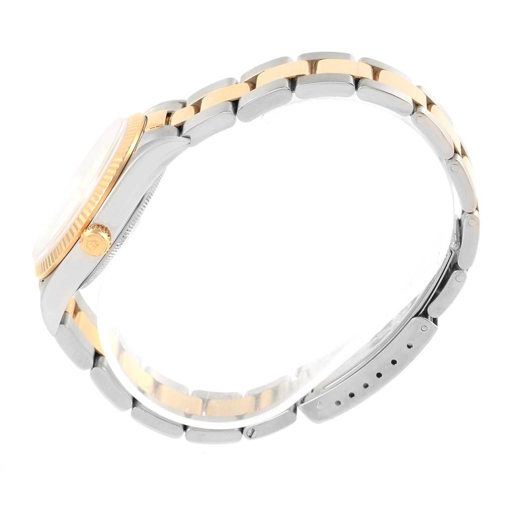 This image shows a side view of the Rolex Oyster Perpetual 14233 Men's Steel and Gold (two tone) White Dial 14233 Men's Steel and Gold (two tone) White Dial watch, highlighting the bracelet, crown, and profile of the case.