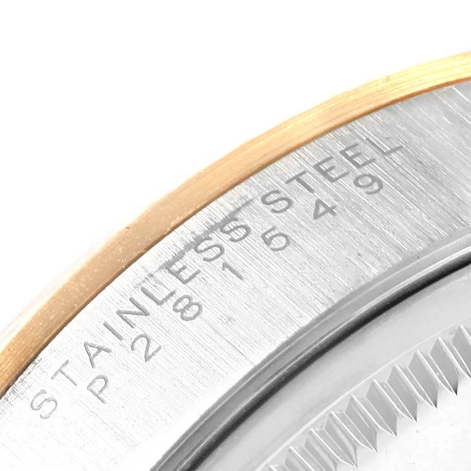 This image shows a close-up view of the side and edge of a Rolex Oyster Perpetual 14233 Men's Steel and Gold (two tone) White Dial 14233 Men's Steel and Gold (two tone) White Dial watch, highlighting the stainless steel and engraved text.