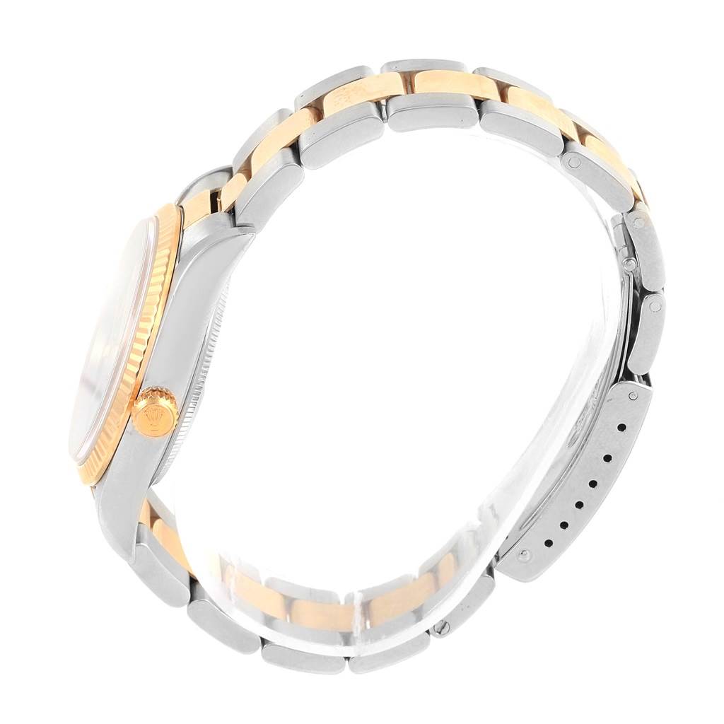 The image shows a side view of a Rolex Oyster Perpetual 14233 Men's Steel and Gold (two tone) Grey Dial 14233 Men's Steel and Gold (two tone) Grey Dial watch, highlighting its two-tone bracelet and crown.