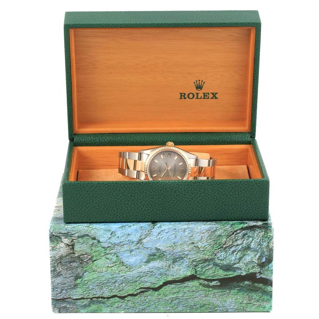 The Rolex Oyster Perpetual 14233 Men's Steel and Gold (two tone) Grey Dial 14233 Men's Steel and Gold (two tone) Grey Dial watch is displayed inside its green and wooden box, showing the full timepiece from the front.