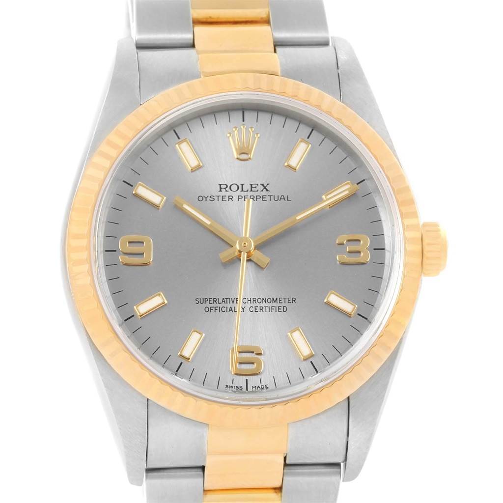 This Rolex Oyster Perpetual 14233 Men's Steel and Gold (two tone) Grey Dial 14233 Men's Steel and Gold (two tone) Grey Dial watch is shown from a front angle, displaying its dial, bezel, hands, and part of the bracelet.