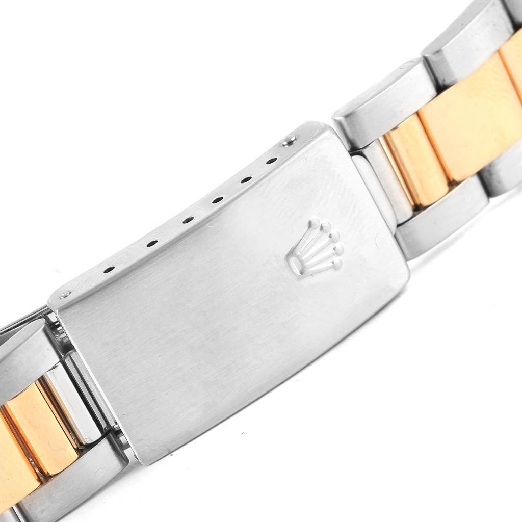 This is a close-up of the clasp and bracelet of a Rolex Oyster Perpetual 14233 Men's Steel and Gold (two tone) Grey Dial 14233 Men's Steel and Gold (two tone) Grey Dial watch, showing the iconic crown logo and two-tone metal design.