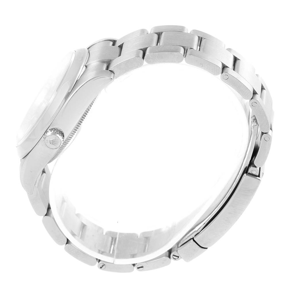 The image shows a side view of a Rolex Oyster Perpetual 114200 Stainless Steel Burgundy Dial 114200 Stainless Steel Burgundy Dial watch, highlighting the bracelet, clasp, and crown.