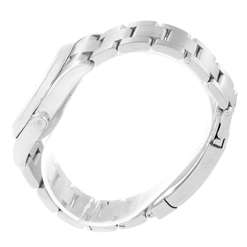 The image shows a side view of a Rolex Oyster Perpetual 116000 Men
s Stainless Steel Silver Dial 116000 Men
s Stainless Steel Silver Dial watch, highlighting the bracelet and part of the case with the crown.