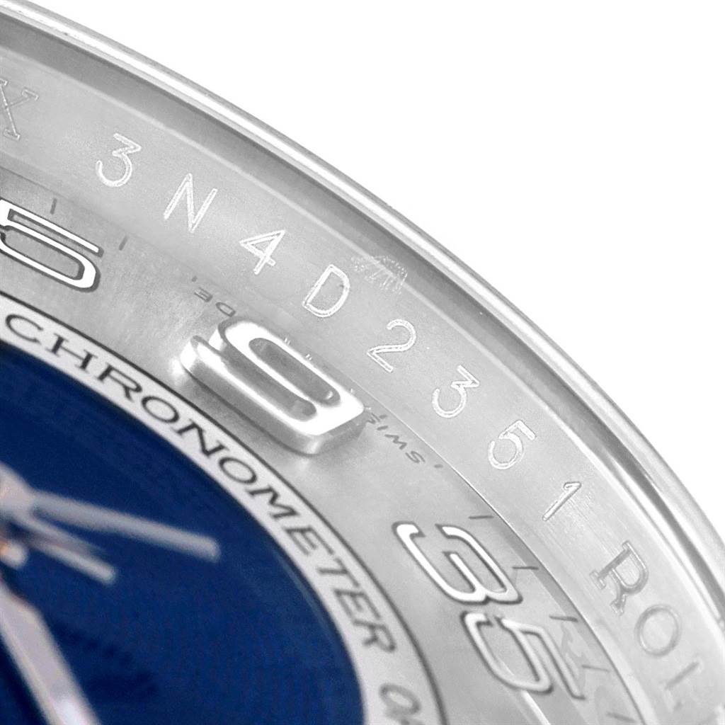 This close-up image shows a section of the dial and bezel of a Rolex Oyster Perpetual 116000 Men
s Stainless Steel Silver Dial 116000 Men
s Stainless Steel Silver Dial watch, highlighting the "0," "5," and chronometer text.