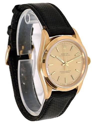 The image shows a side view of a Rolex Oyster Perpetual 14208 Men
s Yellow Gold Champagne Dial 14208 Men
s Yellow Gold Champagne Dial watch, displaying the face, bezel, and black leather strap.