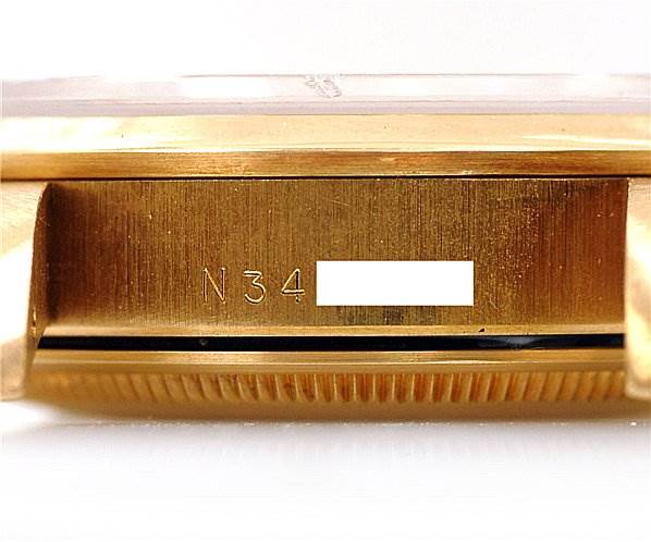 The image shows a close-up of the side case of a Rolex Oyster Perpetual 14208 Men
s Yellow Gold Champagne Dial 14208 Men
s Yellow Gold Champagne Dial watch, displaying the serial number.