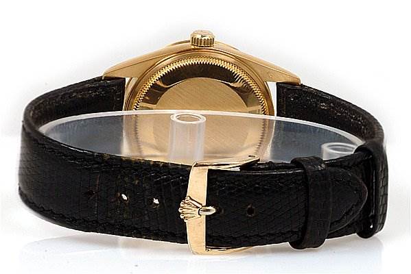 The image shows the back of a Rolex Oyster Perpetual 14208 Men
s Yellow Gold Champagne Dial 14208 Men
s Yellow Gold Champagne Dial watch, highlighting its case, crown, and black leather strap with a gold clasp.