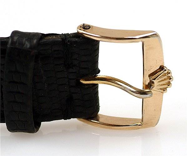 This image shows a close-up of the clasp and leather strap of a Rolex Oyster Perpetual 14208 Men
s Yellow Gold Champagne Dial 14208 Men
s Yellow Gold Champagne Dial watch.