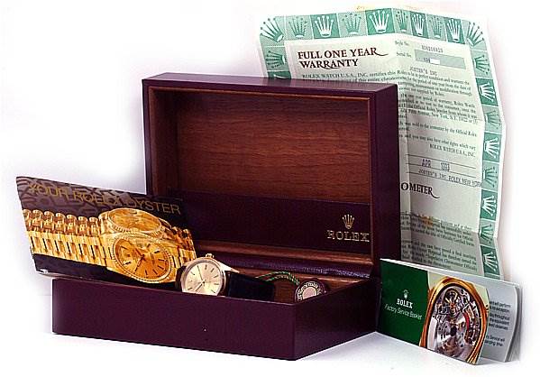 The image shows a Rolex Oyster Perpetual 14208 Men
s Yellow Gold Champagne Dial 14208 Men
s Yellow Gold Champagne Dial watch with its box, warranty card, and informational booklets.