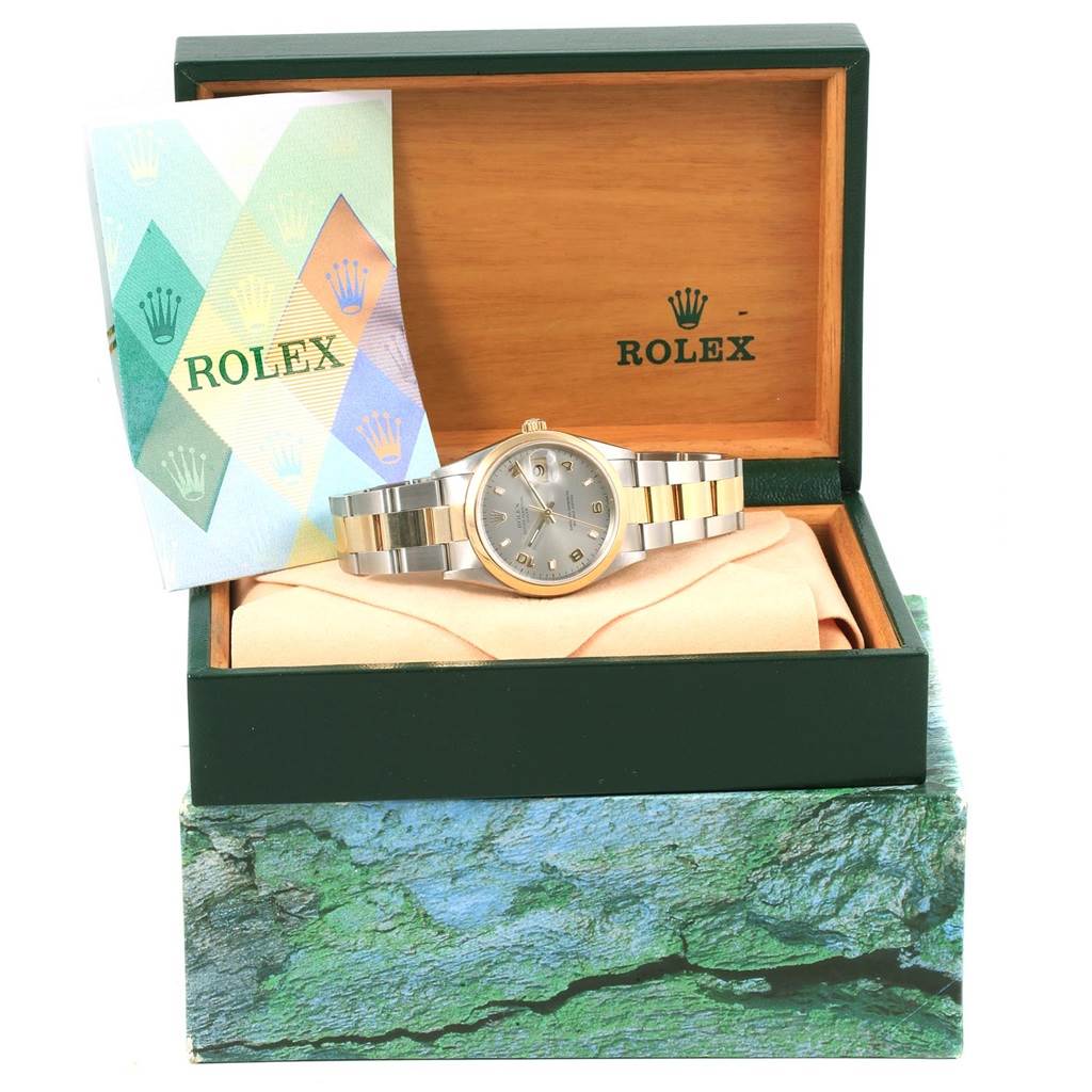 The image shows a Rolex Oyster Perpetual 15203 Men's Steel and Gold (two tone) Grey Dial 15203 Men's Steel and Gold (two tone) Grey Dial watch displayed in an open green and wooden box with a booklet beside it.