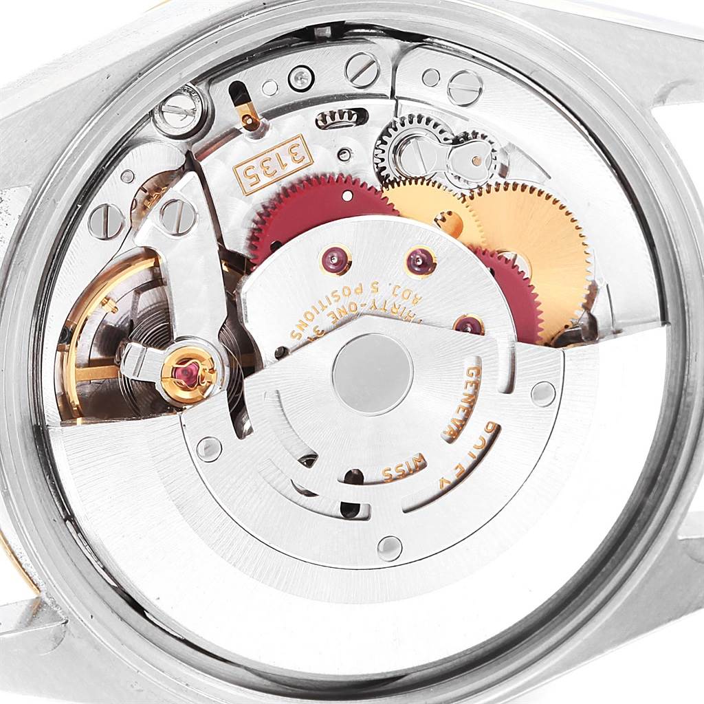 This image shows the internal movement mechanism of a Rolex Oyster Perpetual 15203 Men's Steel and Gold (two tone) Grey Dial 15203 Men's Steel and Gold (two tone) Grey Dial watch, highlighting its gears and components.