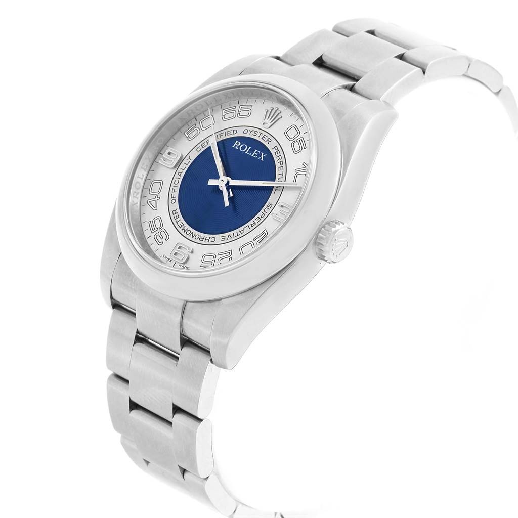 This image shows a Rolex Oyster Perpetual 116000 Men
s Stainless Steel Silver Dial 116000 Men
s Stainless Steel Silver Dial watch from an angled top view, highlighting the dial, bezel, case, crown, and metal bracelet.