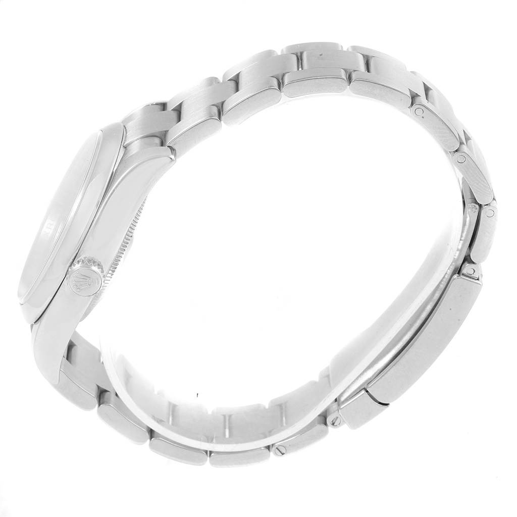 This side view image of a Rolex Oyster Perpetual 116000 Men
s Stainless Steel Silver Dial 116000 Men
s Stainless Steel Silver Dial watch showcases the case, crown, and stainless steel bracelet.