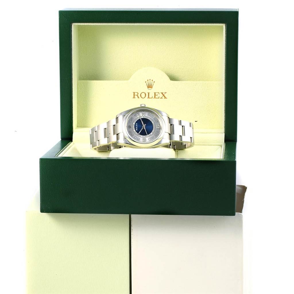 The Rolex Oyster Perpetual 116000 Men
s Stainless Steel Silver Dial 116000 Men
s Stainless Steel Silver Dial watch is shown front-facing within its open green box.