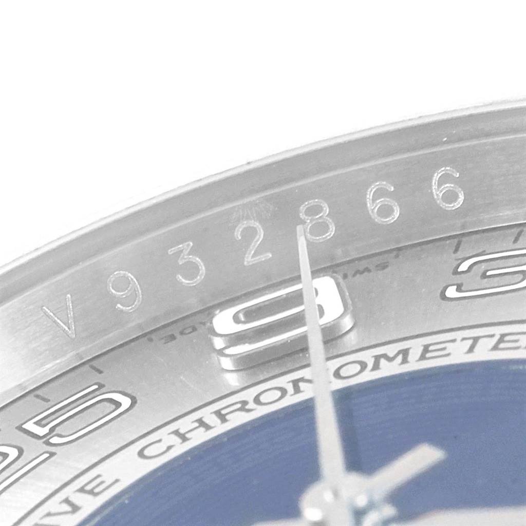 The image shows a close-up of a portion of the dial and case of a Rolex Oyster Perpetual 116000 Men
s Stainless Steel Silver Dial 116000 Men
s Stainless Steel Silver Dial watch, highlighting the serial number.