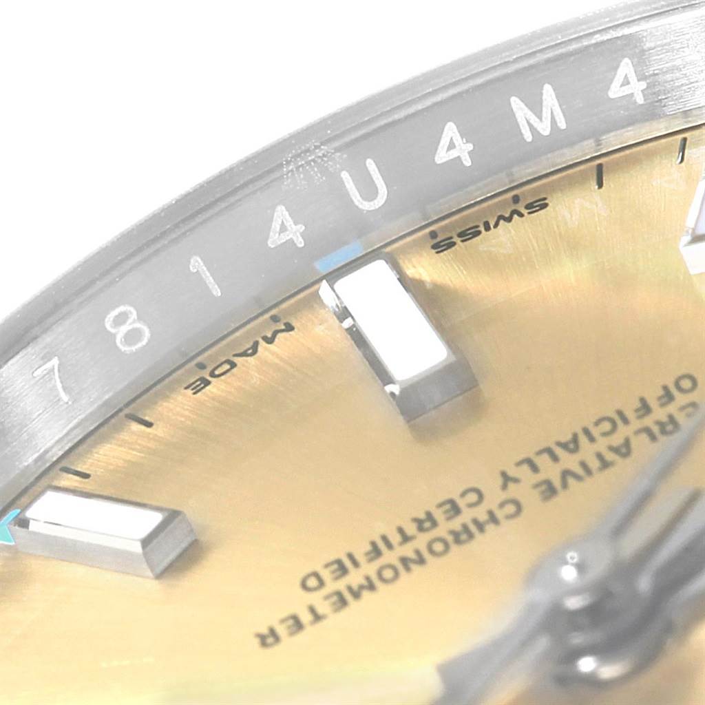 This close-up image shows the dial and the serial number engraving of the Rolex Oyster Perpetual 114200 Stainless Steel Champagne Dial 114200 Stainless Steel Champagne Dial watch.