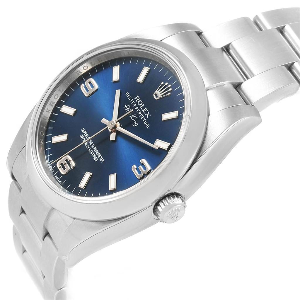 The image shows a Rolex Oyster Perpetual 114200 Men's Stainless Steel Blue Dial 114200 Men's Stainless Steel Blue Dial watch at a slight angle, displaying its face, bezel, crown, and bracelet links.