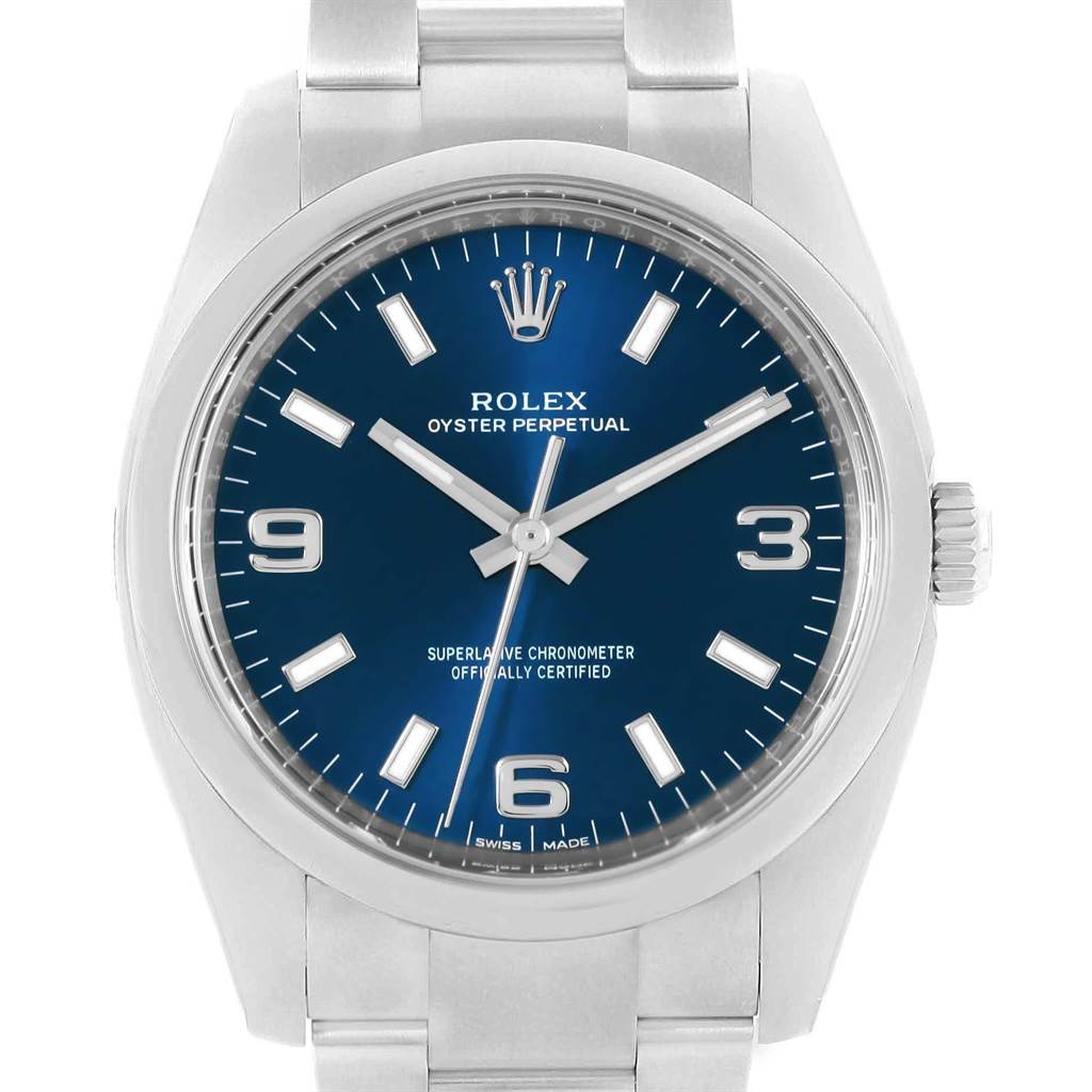 This is a front view of a Rolex Oyster Perpetual 114200 Men's Stainless Steel Blue Dial 114200 Men's Stainless Steel Blue Dial watch displaying its blue dial, hands, hour markers, and partial bracelet.