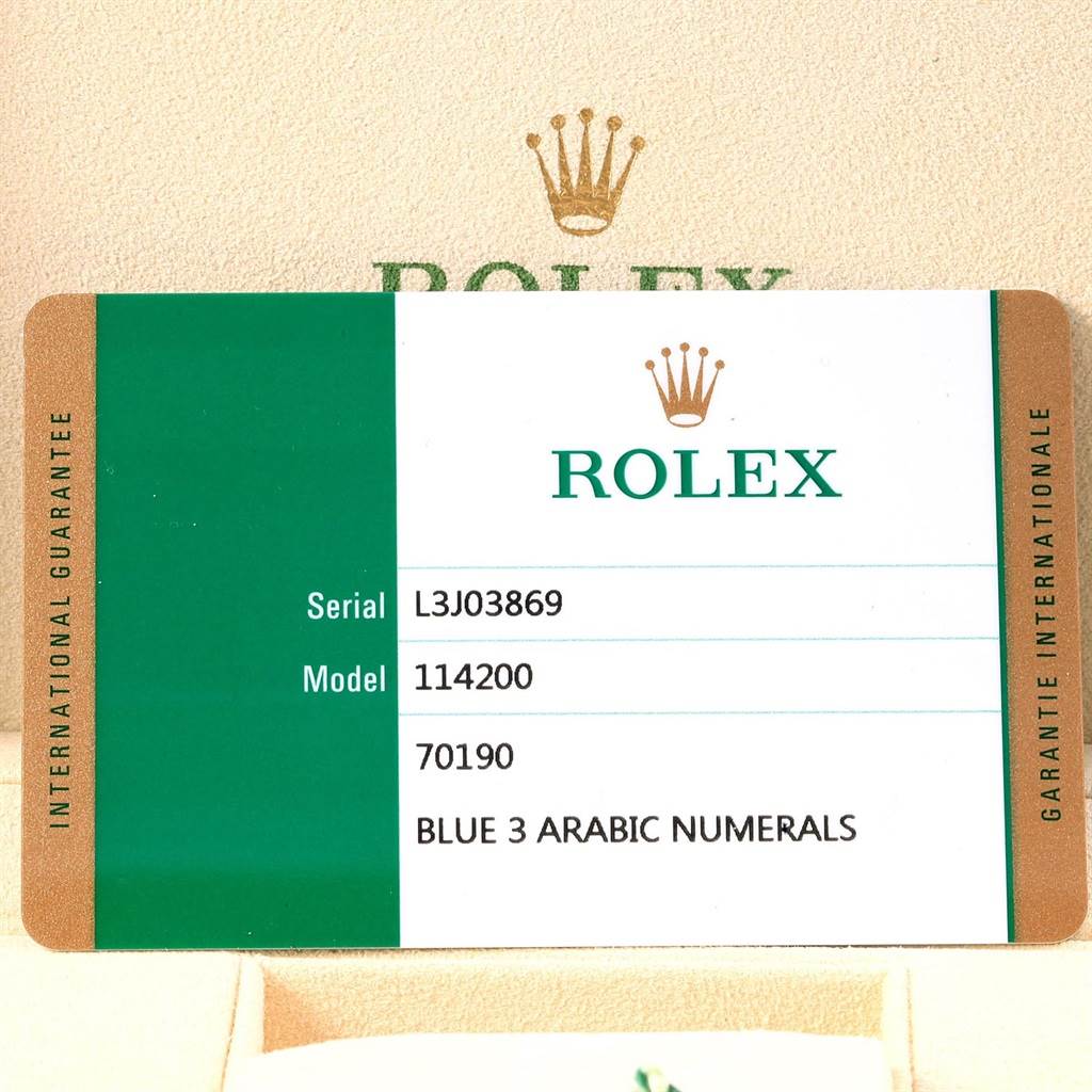 The image shows an international guarantee card for a Rolex Oyster Perpetual 114200 Men's Stainless Steel Blue Dial 114200 Men's Stainless Steel Blue Dial 114200 watch.