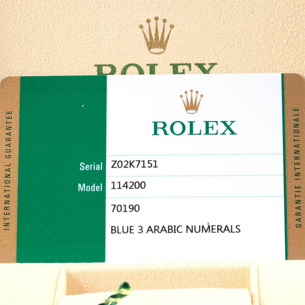 This image shows a close-up of the warranty card for a Rolex Oyster Perpetual 114200 Men's Stainless Steel Blue Dial 114200 Men's Stainless Steel Blue Dial model 114200.
