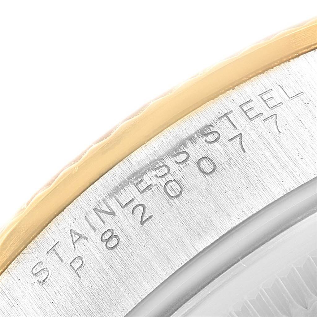This image shows a close-up of the engraved serial number on the back case of a Rolex Oyster Perpetual 14233 Men's Steel and Gold (two tone) Grey Dial 14233 Men's Steel and Gold (two tone) Grey Dial watch.
