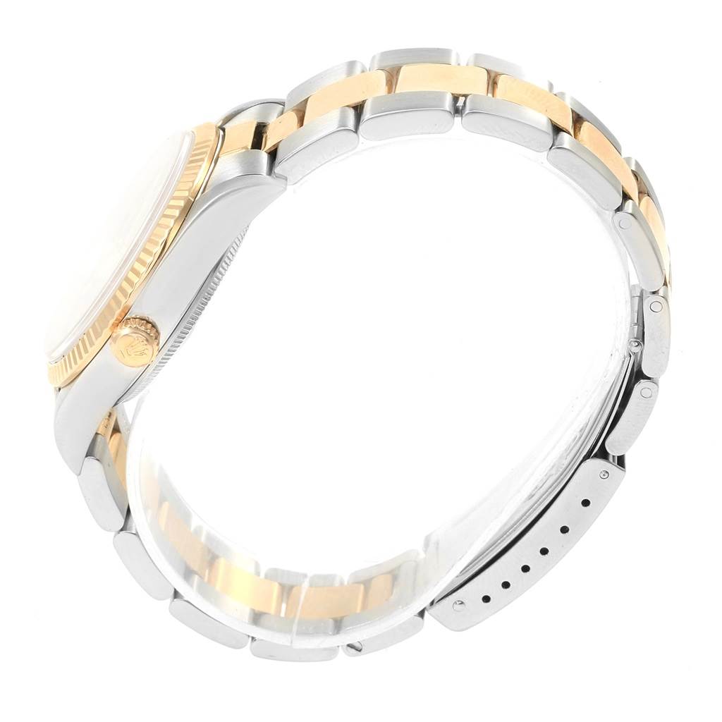 This image shows a side view of the Rolex Oyster Perpetual 14233 Men's Steel and Gold (two tone) Grey Dial 14233 Men's Steel and Gold (two tone) Grey Dial watch, highlighting its two-tone bracelet, crown, and case.