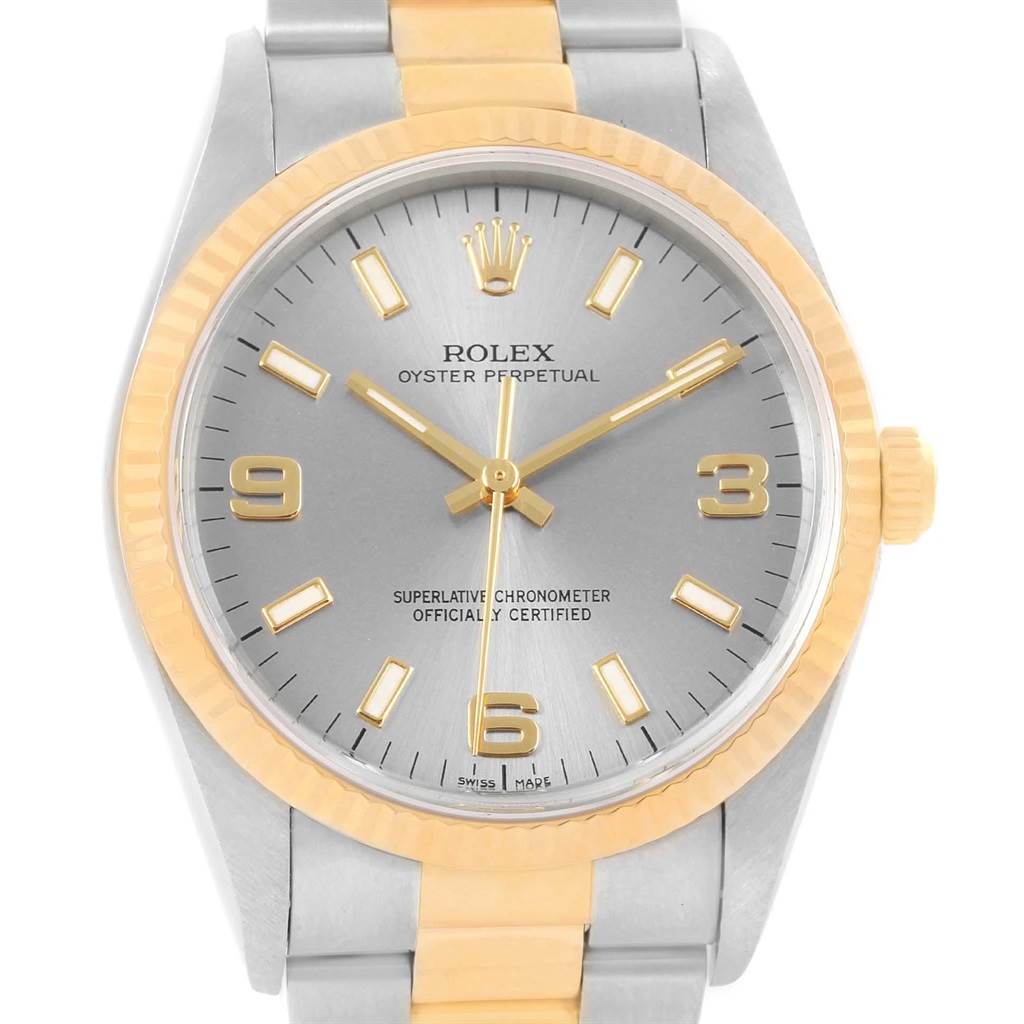 This image shows a front view of a Rolex Oyster Perpetual 14233 Men's Steel and Gold (two tone) Grey Dial 14233 Men's Steel and Gold (two tone) Grey Dial watch, highlighting its dial, hour markers, hands, bezel, and part of the bracelet.