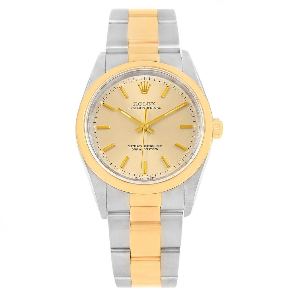 This image shows a front view of the Rolex Oyster Perpetual 14203 Men
s Steel and Gold (two tone) Champagne Dial 14203 Men
s Steel and Gold (two tone) Champagne Dial watch, highlighting its gold and silver design.