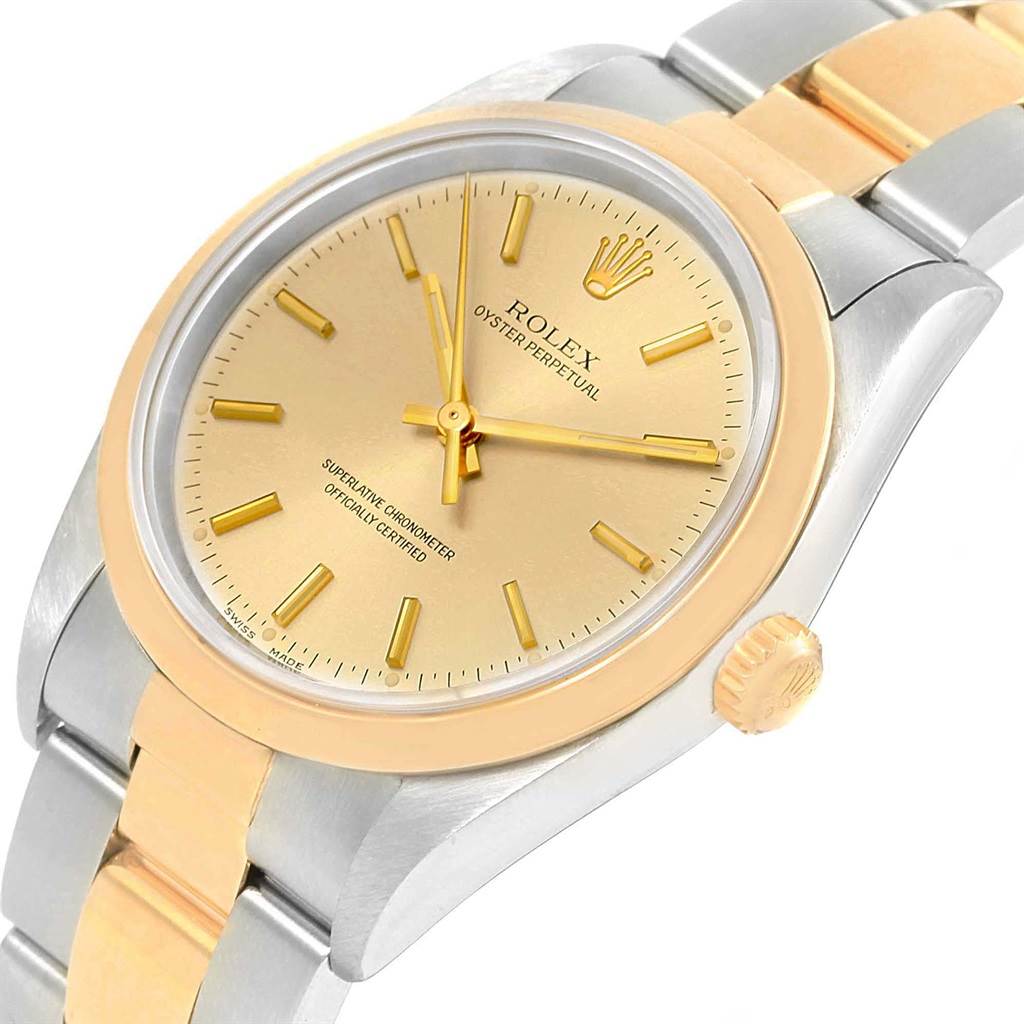 This image shows a close-up angle of the Rolex Oyster Perpetual 14203 Men
s Steel and Gold (two tone) Champagne Dial 14203 Men
s Steel and Gold (two tone) Champagne Dial watch, highlighting its gold dial, bezel, and two-tone bracelet.