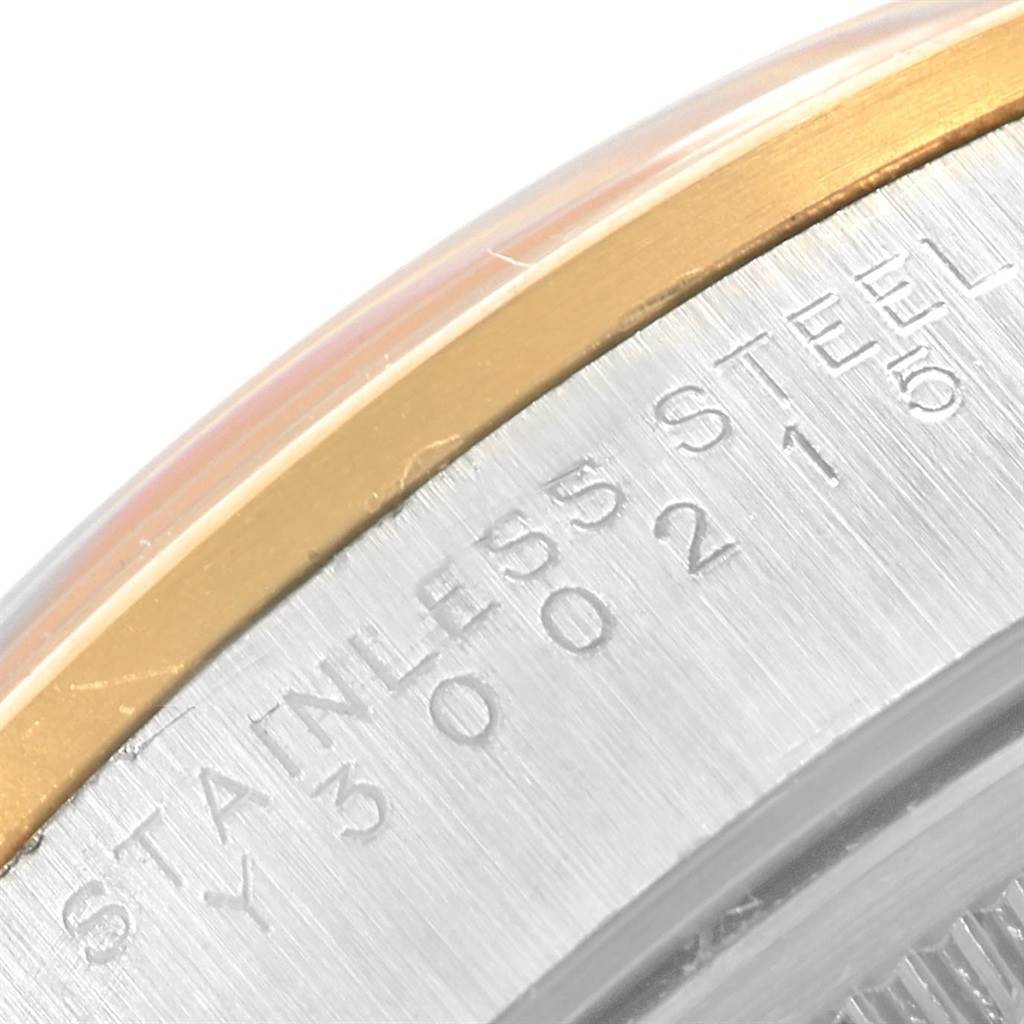 The image shows a close-up of the side engraving and bezel of a Rolex Oyster Perpetual 14203 Men
s Steel and Gold (two tone) Champagne Dial 14203 Men
s Steel and Gold (two tone) Champagne Dial watch, highlighting the "STAINLESS STEEL" marking.
