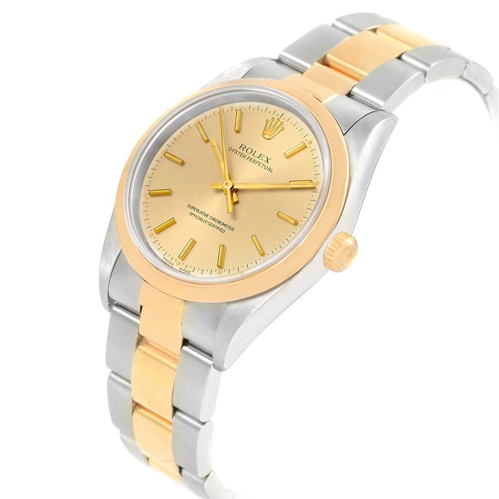 The image shows a side angle of the Rolex Oyster Perpetual 14203 Men
s Steel and Gold (two tone) Champagne Dial 14203 Men
s Steel and Gold (two tone) Champagne Dial watch, highlighting the dial, bezel, and two-tone bracelet.