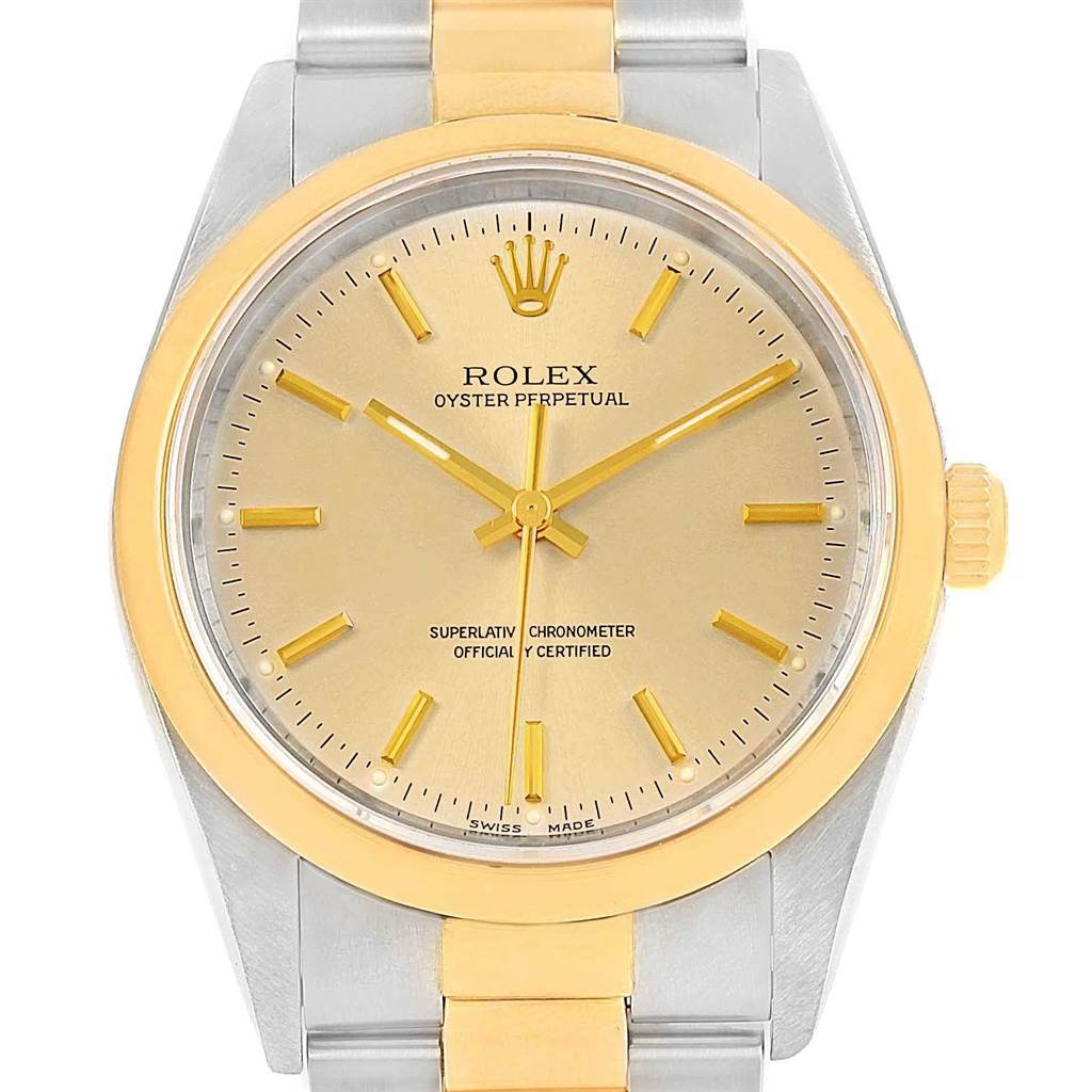 The Rolex Oyster Perpetual 14203 Men
s Steel and Gold (two tone) Champagne Dial 14203 Men
s Steel and Gold (two tone) Champagne Dial model is shown from a front angle, highlighting the gold bezel, dial, and crown, along with the two-tone bracelet.