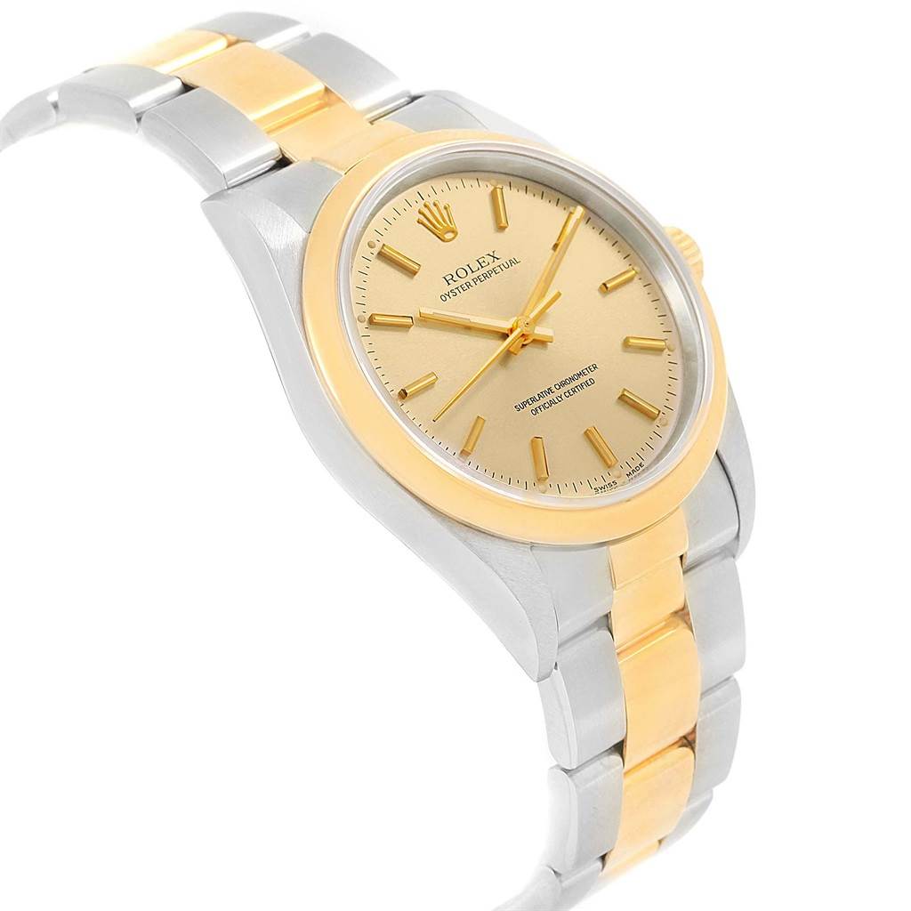 This image shows a Rolex Oyster Perpetual 14203 Men
s Steel and Gold (two tone) Champagne Dial 14203 Men
s Steel and Gold (two tone) Champagne Dial watch in a side view angle, displaying its two-tone bracelet and champagne-colored dial.