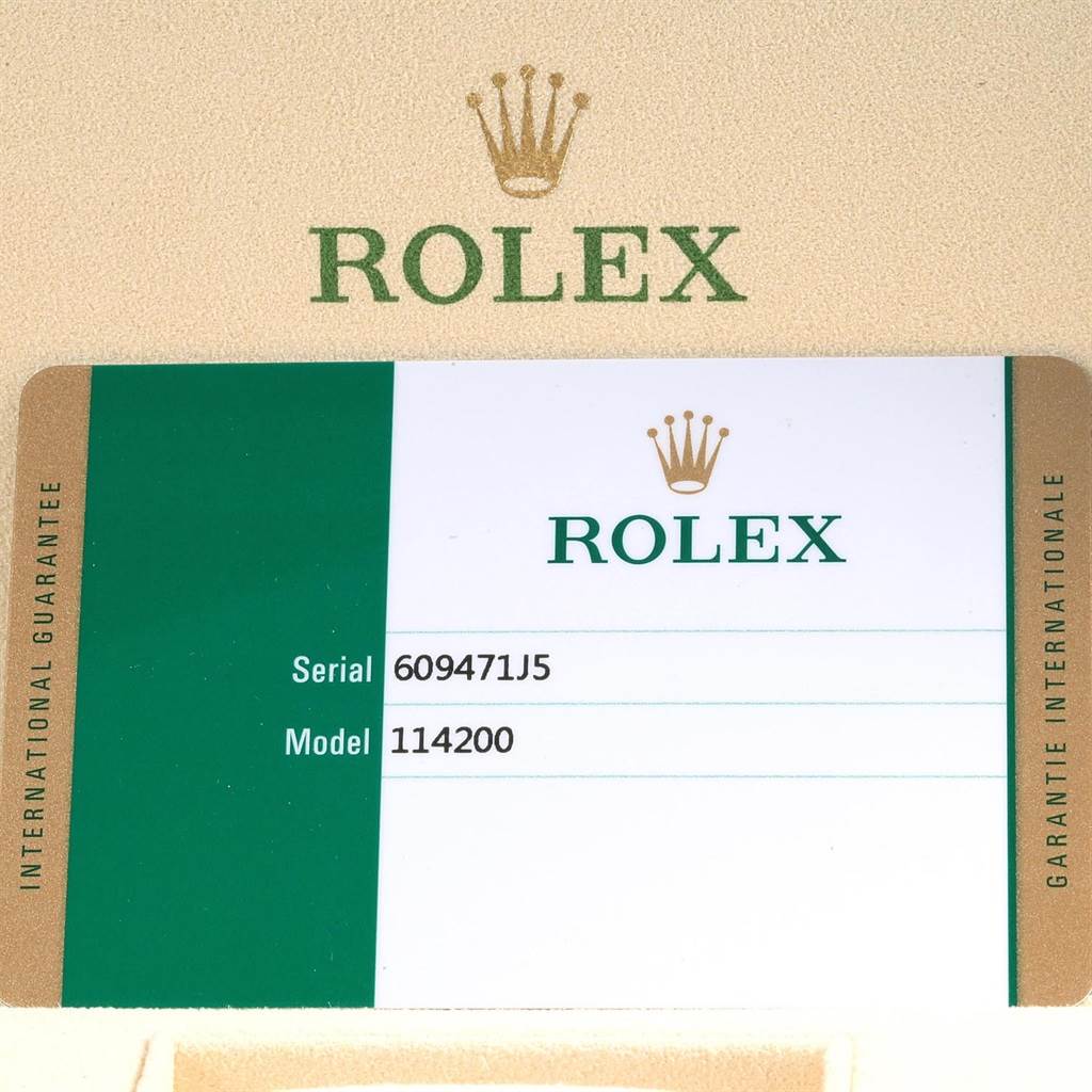 This image shows a Rolex Oyster Perpetual 60947155 Stainless Steel Champagne Dial 60947155 Stainless Steel Champagne Dial warranty card displaying the serial number and model number 114200.