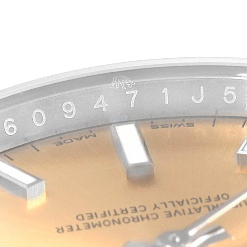 This close-up image shows the dial and part of the serial number on the Rolex Oyster Perpetual 60947155 Stainless Steel Champagne Dial 60947155 Stainless Steel Champagne Dial watch.