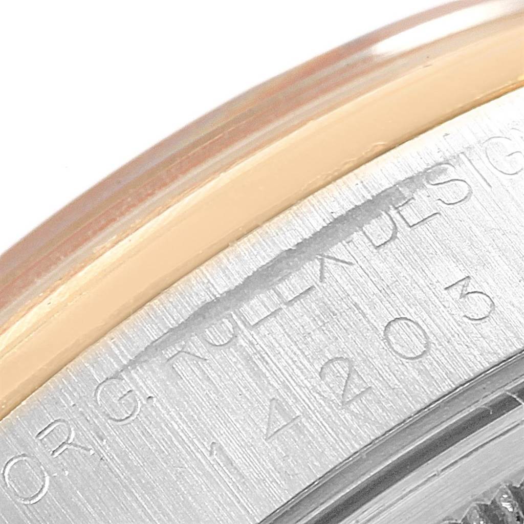 This close-up image shows the side casing and edge engraving of a Rolex Oyster Perpetual 14203 Men's Steel and Gold (two tone) Grey Dial 14203 Men's Steel and Gold (two tone) Grey Dial.