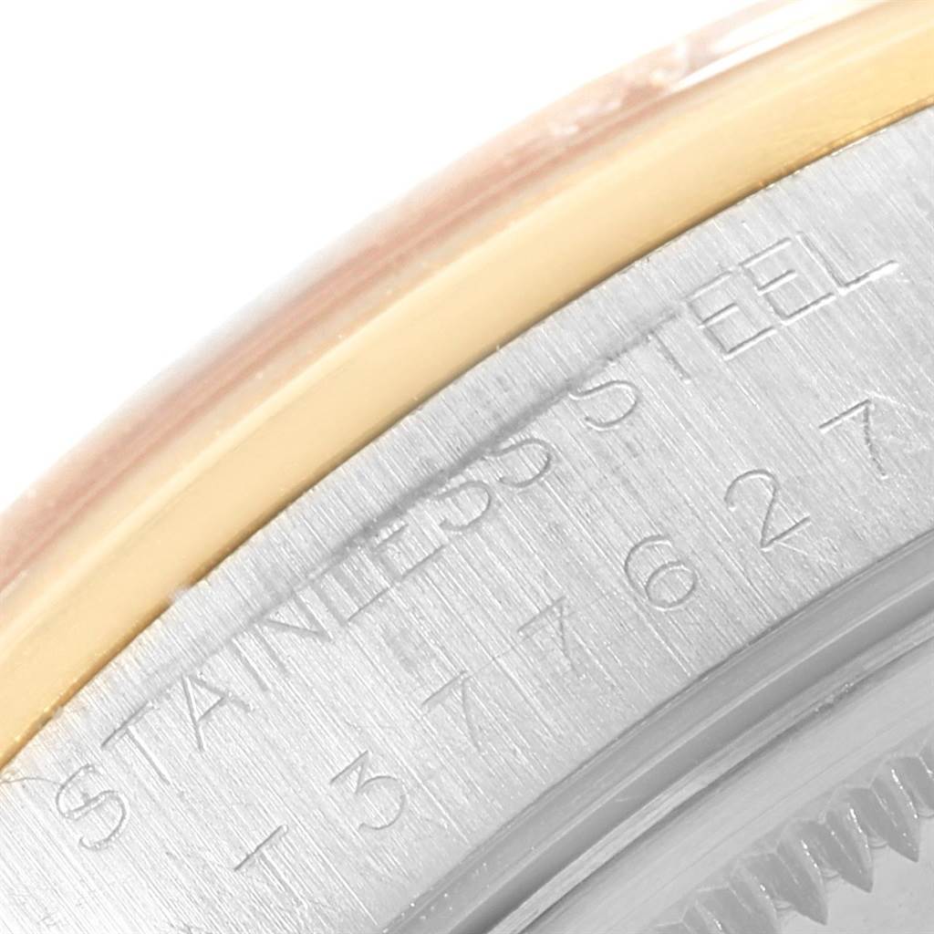 This close-up image shows the outer case and bezel of a Rolex Oyster Perpetual 14203 Men's Steel and Gold (two tone) Grey Dial 14203 Men's Steel and Gold (two tone) Grey Dial watch, highlighting the “STAINLESS STEEL” engraving.
