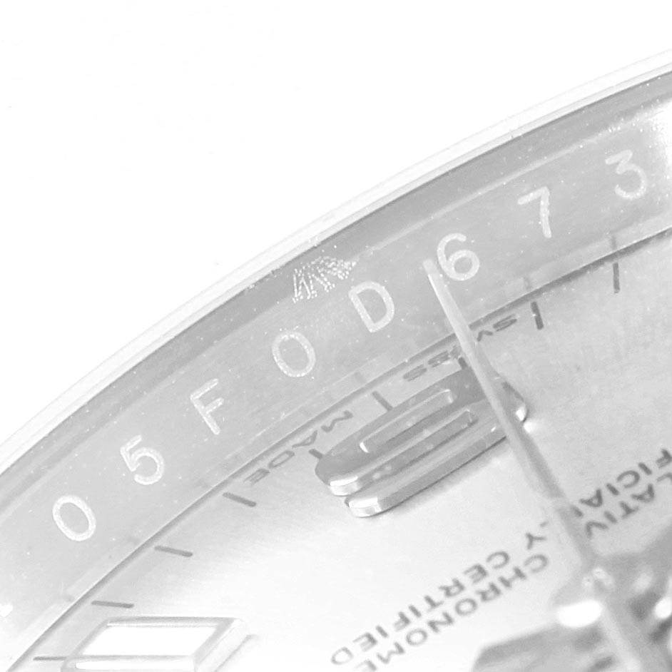 This image shows a close-up of the dial and part of the bezel of a Rolex Oyster Perpetual 114200 Men's Stainless Steel Silver Dial 114200 Men's Stainless Steel Silver Dial watch.