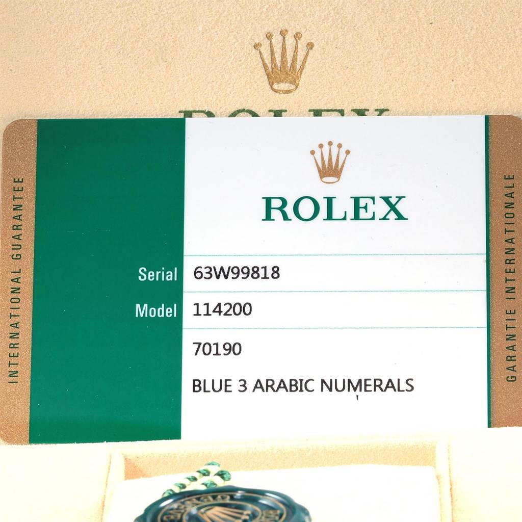 This image shows the guarantee card for a Rolex Oyster Perpetual 114200 Men's Stainless Steel Blue Dial 114200 Men's Stainless Steel Blue Dial model 114200, displaying serial number, model number, and other details.