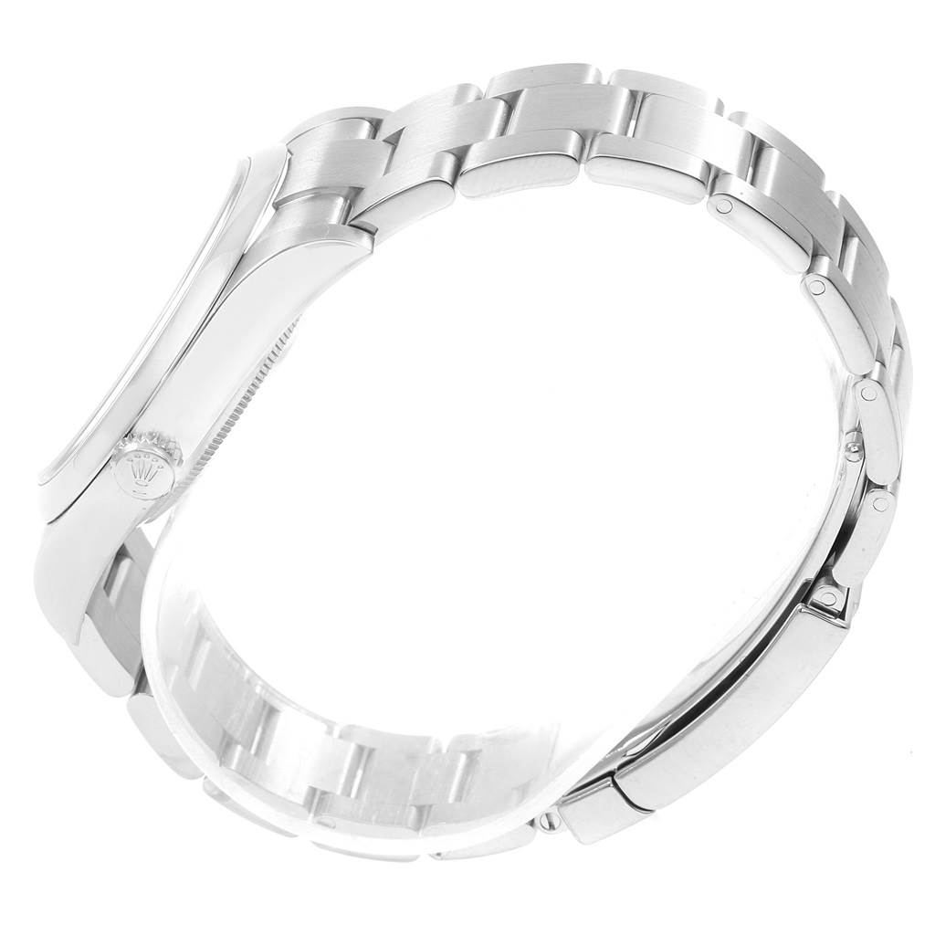 This side view of the Rolex Oyster Perpetual 114300 Men's Stainless Steel Blue Dial 114300 Men's Stainless Steel Blue Dial shows the case, crown, and bracelet.