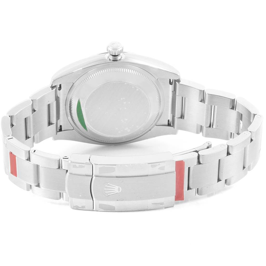 The image shows the back view of a Rolex Oyster Perpetual 114200 Men's Stainless Steel Blue Dial 114200 Men's Stainless Steel Blue Dial watch, highlighting the clasp and bracelet.