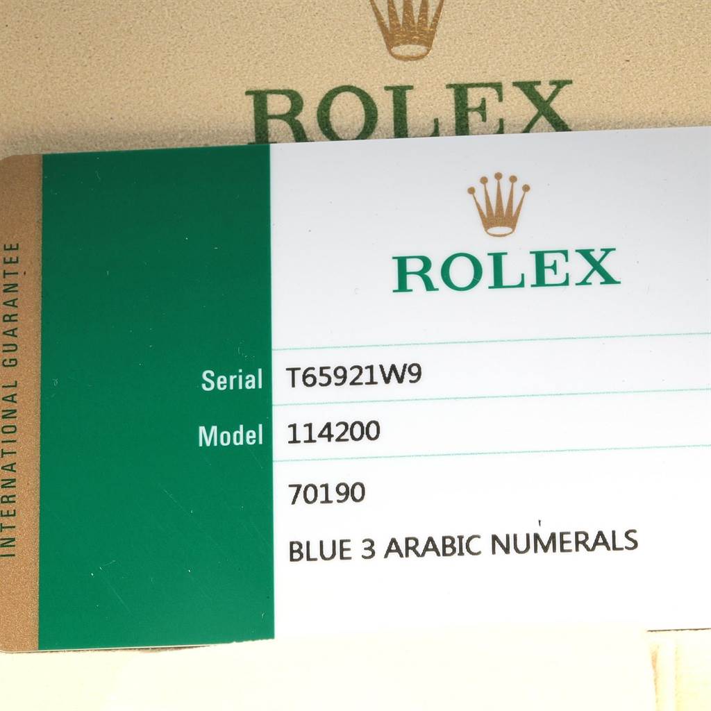 The image shows an international guarantee card for a Rolex Oyster Perpetual 114200 Men's Stainless Steel Blue Dial 114200 Men's Stainless Steel Blue Dial model 114200 watch.