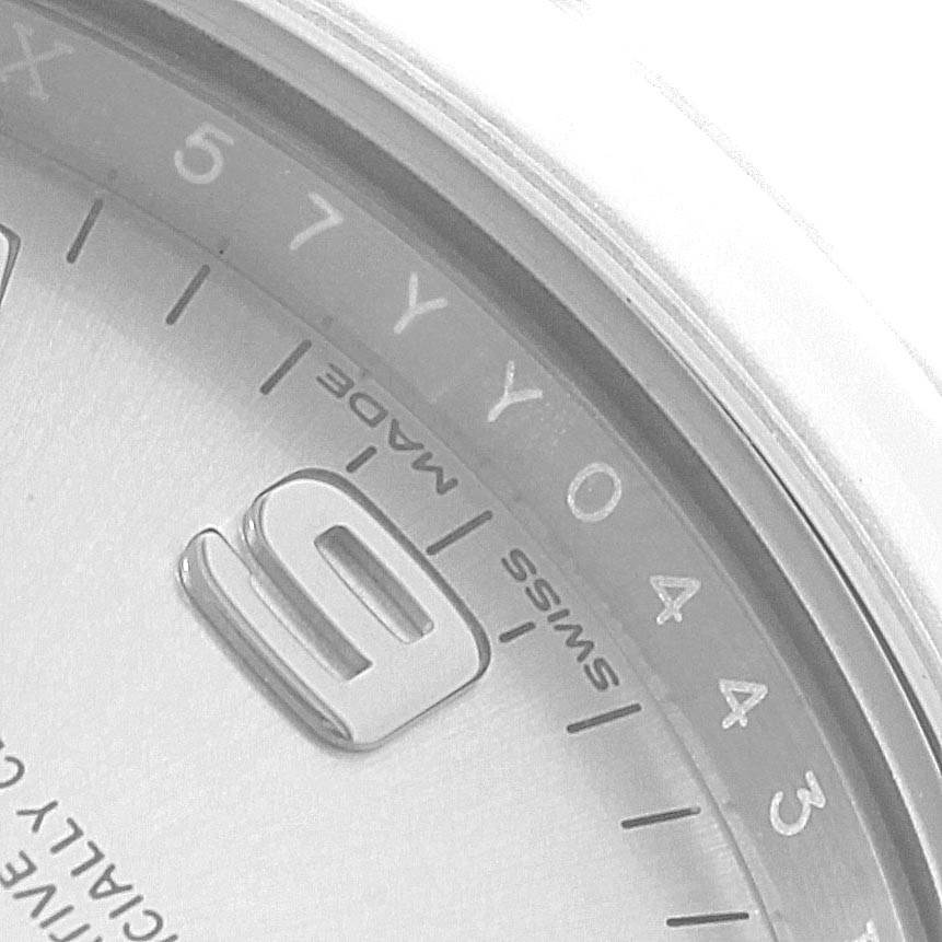 The image shows a close-up of the dial and bezel of a Rolex Oyster Perpetual 114200 Men's Stainless Steel Silver Dial 114200 Men's Stainless Steel Silver Dial watch.