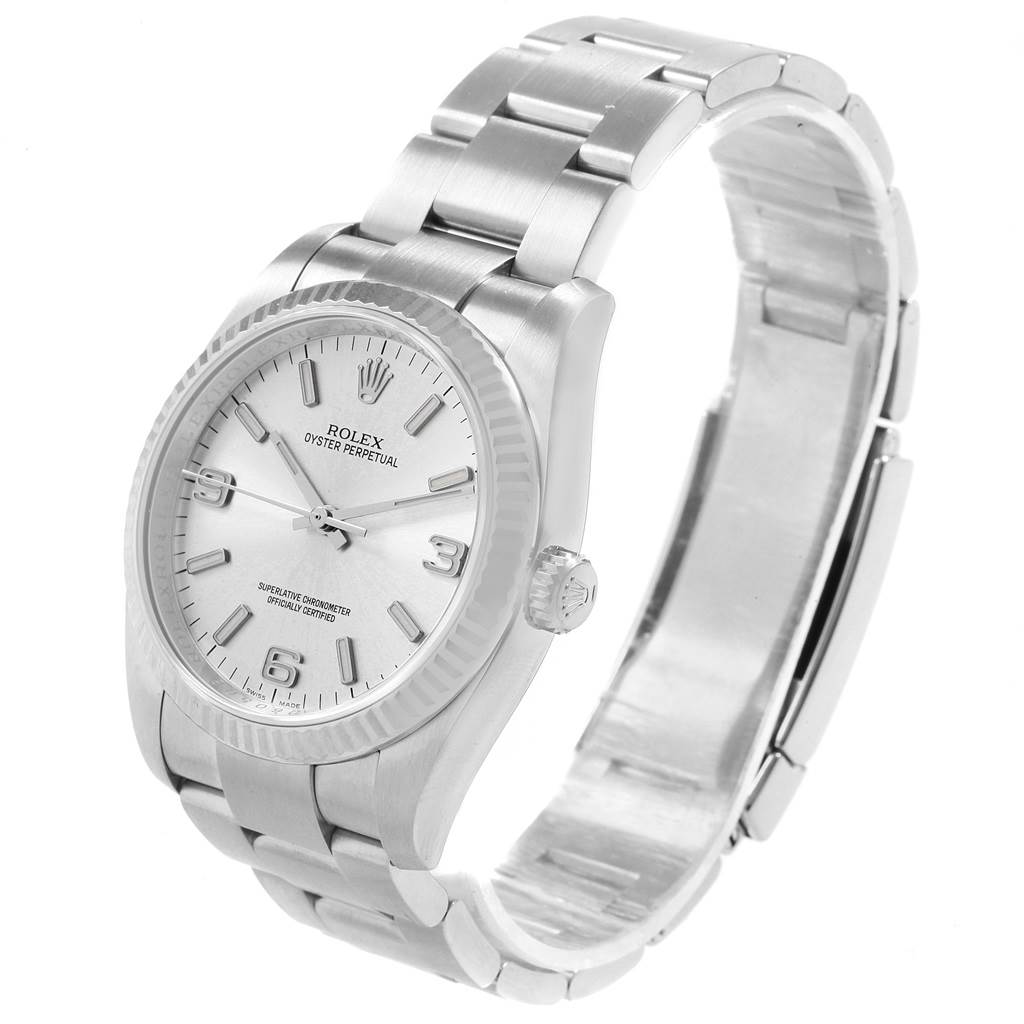 The image shows a Rolex Oyster Perpetual 116034 Men's Stainless Steel Silver Dial 116034 Men's Stainless Steel Silver Dial watch from a three-quarter angle, highlighting its dial, bezel, bracelet, and crown.