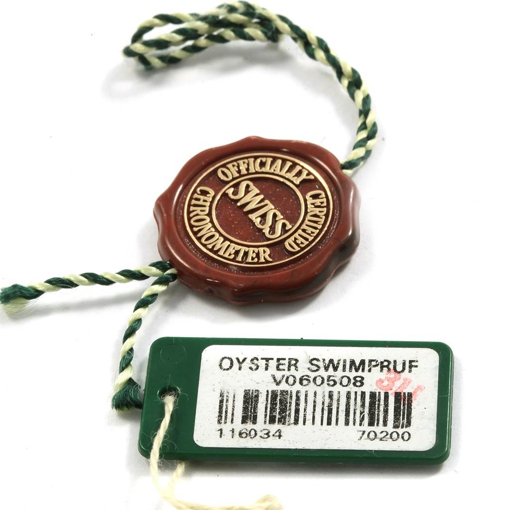 This image shows the certification tag and Swimpruf tag for the Rolex Oyster Perpetual 116034 Men's Stainless Steel Silver Dial 116034 Men's Stainless Steel Silver Dial watch model.
