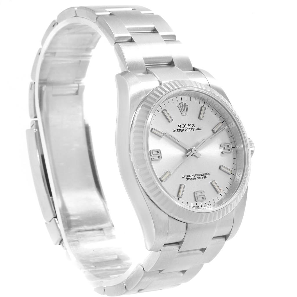 The image shows a Rolex Oyster Perpetual 116034 Men's Stainless Steel Silver Dial 116034 Men's Stainless Steel Silver Dial watch from an angled side view displaying the dial, bezel, and part of the bracelet.