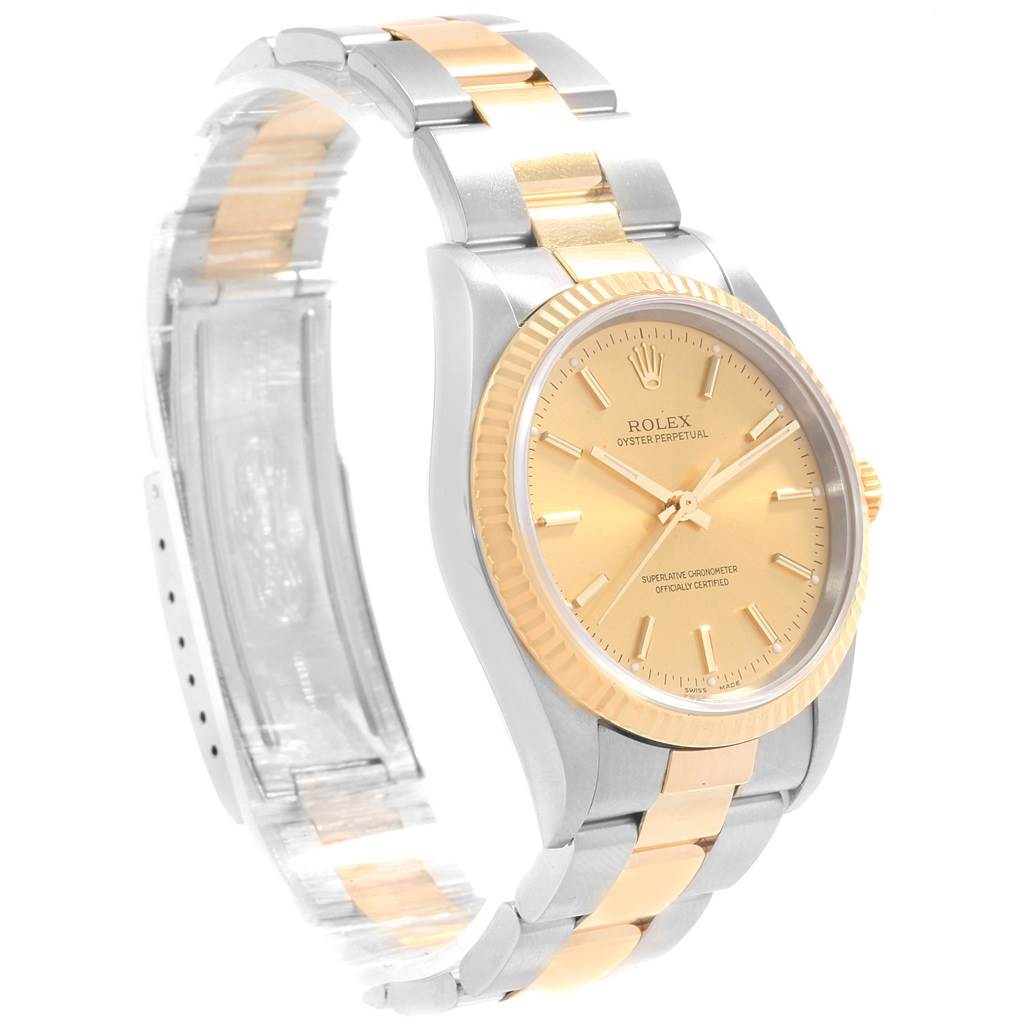 The image shows a Rolex Oyster Perpetual 14233 Men's Steel and Gold (two tone) Champagne Dial 14233 Men's Steel and Gold (two tone) Champagne Dial watch angled to display the face, bezel, and two-tone bracelet clearly.